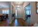 Inviting foyer featuring wood-look tile floors and natural light, flowing into adjacent living spaces at 19232 Park Place Blvd, Eustis, FL 32736