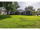Well maintained single story home with a manicured front lawn and mature trees at 19232 Park Place Blvd, Eustis, FL 32736