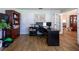 Home office featuring hardwood floors, a large desk, and built-in shelving at 19232 Park Place Blvd, Eustis, FL 32736