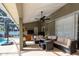 Covered patio with comfortable seating, outdoor kitchen, and a view of the pool at 19232 Park Place Blvd, Eustis, FL 32736