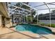 Screened-in pool and spa with surrounding patio area and lush landscaping provide a relaxing outdoor retreat at 19232 Park Place Blvd, Eustis, FL 32736