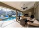 Beautiful pool area with a covered patio, outdoor kitchen, and lush landscaping at 19232 Park Place Blvd, Eustis, FL 32736