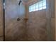 Modern shower with glass enclosure, rainfall showerhead, and tiled surround at 19232 Park Place Blvd, Eustis, FL 32736