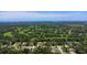 An aerial view of a suburban neighborhood with single-Gathering homes near a golf course at 204 Rio Pinar Dr, Ormond Beach, FL 32174