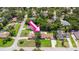 An aerial view of a residential area with lush greenery, well-manicured lawns, and mature trees at 204 Rio Pinar Dr, Ormond Beach, FL 32174
