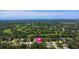 Aerial view of homes near golf course and ocean, marked with location pin at 204 Rio Pinar Dr, Ormond Beach, FL 32174
