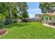 Lush backyard with a well-maintained lawn, featuring a privacy fence and storage shed at 204 Rio Pinar Dr, Ormond Beach, FL 32174