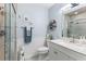 Cozy bathroom with a glass enclosed shower, modern sink, vanity, and decorative shelving at 204 Rio Pinar Dr, Ormond Beach, FL 32174