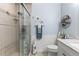 Charming bathroom featuring a glass enclosed shower, toilet, and vanity with shelving at 204 Rio Pinar Dr, Ormond Beach, FL 32174