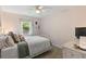 Comfortable bedroom featuring a bed with cozy pillows, dresser, and natural light at 204 Rio Pinar Dr, Ormond Beach, FL 32174
