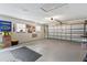 Spacious garage with ample storage, fan decor, an American flag, and a standard roll-up door at 204 Rio Pinar Dr, Ormond Beach, FL 32174