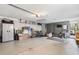 Organized garage featuring storage cabinets, shelving, exercise equipment, and overhead lighting at 204 Rio Pinar Dr, Ormond Beach, FL 32174