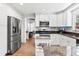 Updated kitchen with white cabinets, stainless steel appliances, and granite countertops at 204 Rio Pinar Dr, Ormond Beach, FL 32174
