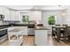 Bright kitchen with white cabinets, stainless appliances, and granite countertops at 204 Rio Pinar Dr, Ormond Beach, FL 32174