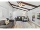 Spacious living room featuring wood beam ceilings, large rug, and comfortable seating at 204 Rio Pinar Dr, Ormond Beach, FL 32174