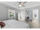 Bright main bedroom features a ceiling fan, ensuite bathroom, and natural light from the window at 204 Rio Pinar Dr, Ormond Beach, FL 32174