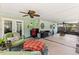 Spacious screened patio with ceiling fans, outdoor furniture, and ample space for entertaining at 204 Rio Pinar Dr, Ormond Beach, FL 32174
