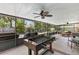 Spacious screened porch with outdoor seating, a ceiling fan, string lights, and a foosball table at 204 Rio Pinar Dr, Ormond Beach, FL 32174