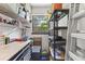 Functional storage area with shelving units, a window for natural light, and workbench space at 204 Rio Pinar Dr, Ormond Beach, FL 32174