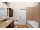 Well-lit bathroom with granite counters, wood cabinets, a soaking tub and tile floors at 2263 Catbriar Way, Oviedo, FL 32765
