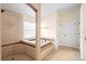 Bright bathroom features a tiled shower, separate soaking tub, and lots of natural light at 2263 Catbriar Way, Oviedo, FL 32765