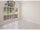 Light-filled bedroom showcasing a large arched window overlooking the front yard at 2263 Catbriar Way, Oviedo, FL 32765