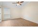 Bedroom featuring wood flooring, a window with blinds, and neutral walls at 2263 Catbriar Way, Oviedo, FL 32765