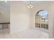 Dining room with tile floors, a hanging chandelier, and bright arched window at 2263 Catbriar Way, Oviedo, FL 32765