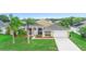 Charming one-story home featuring a well-manicured lawn, palm trees, and a two-car garage at 2263 Catbriar Way, Oviedo, FL 32765