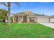Charming single-story home with a well-manicured lawn, lush landscaping, and a two-car garage at 2263 Catbriar Way, Oviedo, FL 32765