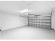 Clean, empty garage with neutral color, automatic door, and plenty of space for storage and vehicles at 2263 Catbriar Way, Oviedo, FL 32765