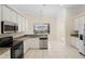 Well-lit kitchen featuring granite countertops, white cabinets, and stainless steel appliances at 2263 Catbriar Way, Oviedo, FL 32765