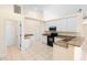 Well-lit kitchen featuring granite countertops, stainless steel appliances, and white cabinetry at 2263 Catbriar Way, Oviedo, FL 32765