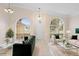 Bright living room showcasing large windows, tile flooring, and stylish furniture at 2263 Catbriar Way, Oviedo, FL 32765