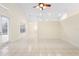 Open living room area with tiled floors and access to the backyard through a glass door at 2263 Catbriar Way, Oviedo, FL 32765