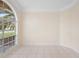 Bright living room features tile flooring, neutral paint and arch window at 2263 Catbriar Way, Oviedo, FL 32765