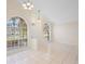 Open living room features tile flooring, high ceilings, and arch windows at 2263 Catbriar Way, Oviedo, FL 32765