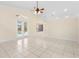 Open living space with tile floors, neutral walls, and a view of the pool through glass doors at 2263 Catbriar Way, Oviedo, FL 32765