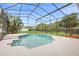 Beautiful screened pool is surrounded by lush landscaping, creating a private oasis for relaxation and recreation at 2263 Catbriar Way, Oviedo, FL 32765