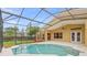 Screened-in pool area with large pool, attractive pavers, and access to backyard at 2263 Catbriar Way, Oviedo, FL 32765