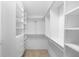 A walk-in closet with custom shelving and built-in drawers for organization at 2263 Catbriar Way, Oviedo, FL 32765