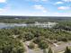 Scenic aerial shot of a property with lake, highlighting the desirable neighborhood's natural beauty and convenient road access at 2620 Doyle Rd, Deltona, FL 32738
