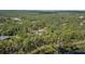 Scenic aerial view of a home nestled amongst mature trees with lake frontage at 2620 Doyle Rd, Deltona, FL 32738