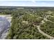 Beautiful aerial view of property showing lake access, trees, and community, ideal for those seeking serene environment at 2620 Doyle Rd, Deltona, FL 32738