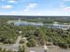 Stunning aerial of a property near a winding road and lake, highlighting lush greenery and neighborhood's scenic surroundings at 2620 Doyle Rd, Deltona, FL 32738