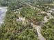 Lakefront property aerial view of a home and the surrounding community, showcasing lush greenery and convenient road access at 2620 Doyle Rd, Deltona, FL 32738