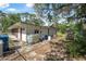 Rear exterior of property with storage tanks and wooded views at 2620 Doyle Rd, Deltona, FL 32738
