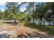 Spacious backyard with mature trees and a glimpse of the house, blending nature and home at 2620 Doyle Rd, Deltona, FL 32738