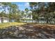 Expansive backyard with mature trees and a serene lake view, perfect for outdoor activities at 2620 Doyle Rd, Deltona, FL 32738