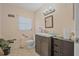 Bathroom with a vanity, toilet, accessible hand bar, and decorative plant at 2620 Doyle Rd, Deltona, FL 32738